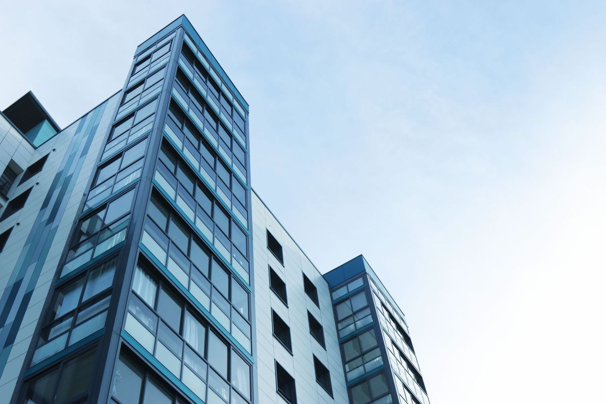 Modern high-rise condominium towers against a blue sky